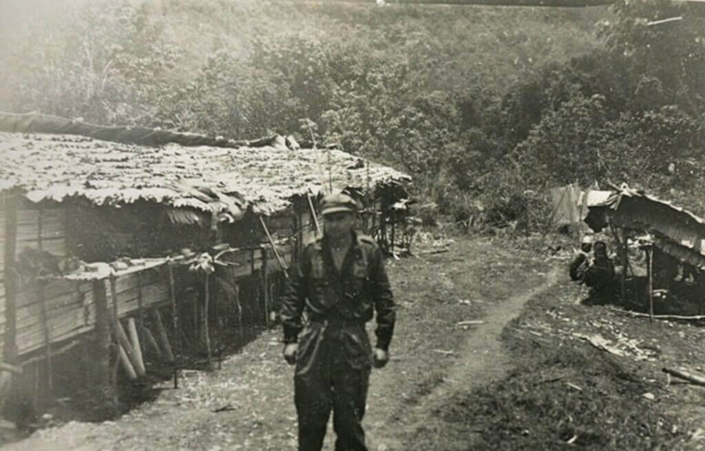 Old photograph of Tom Harnett Harrisson standing in the Japanese jungle of Borneo